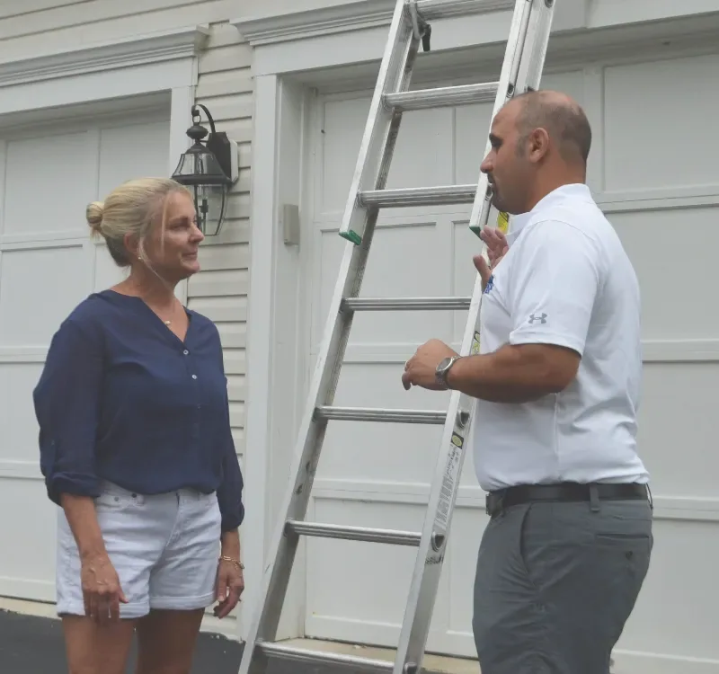 Ridgeline Roofers owner walking a homeowner through her roof estimate
